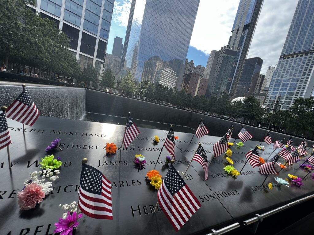 Flags and flowers around the 9/11 memorial